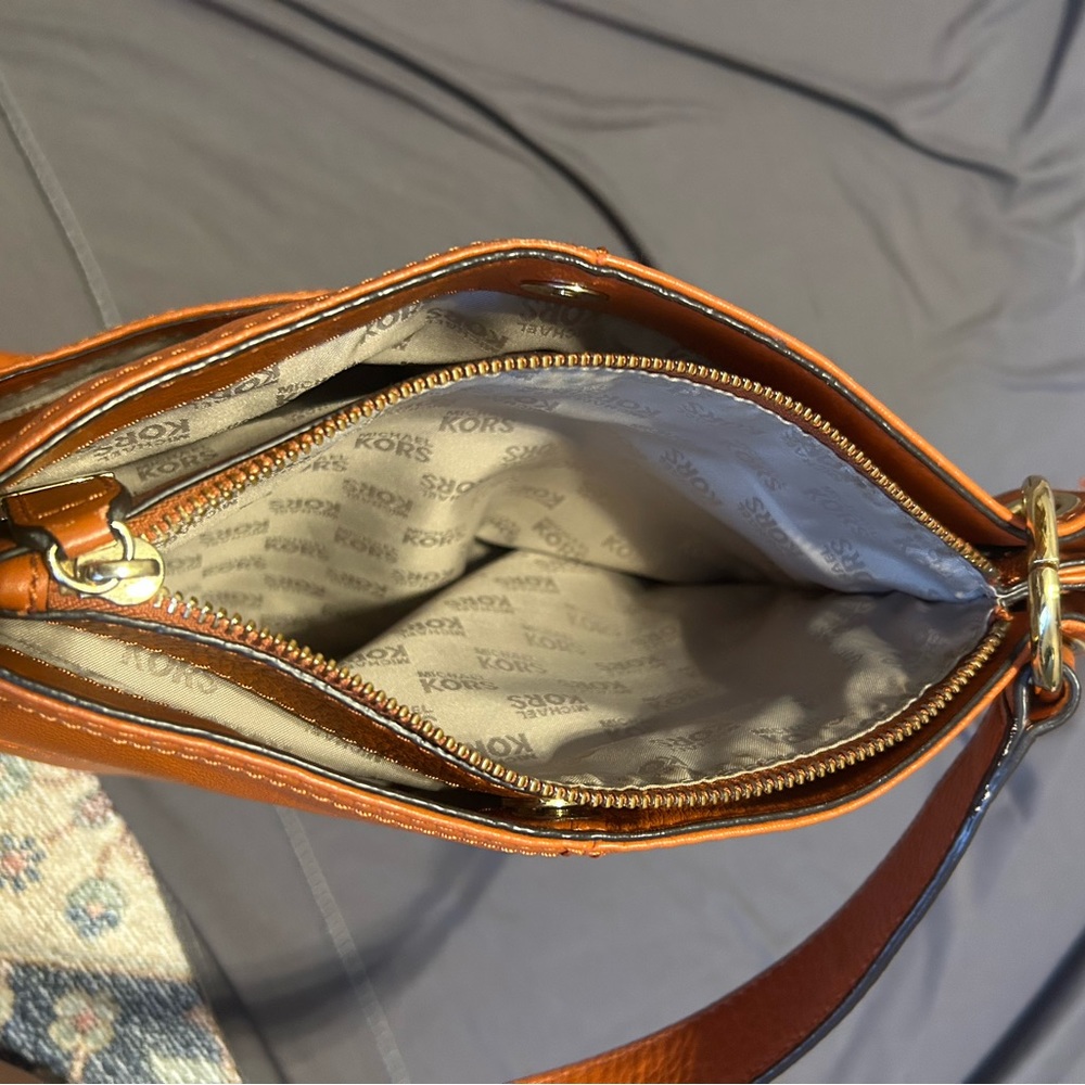 Michael Kors medium size handbag with one shoulder strap and zipper on top